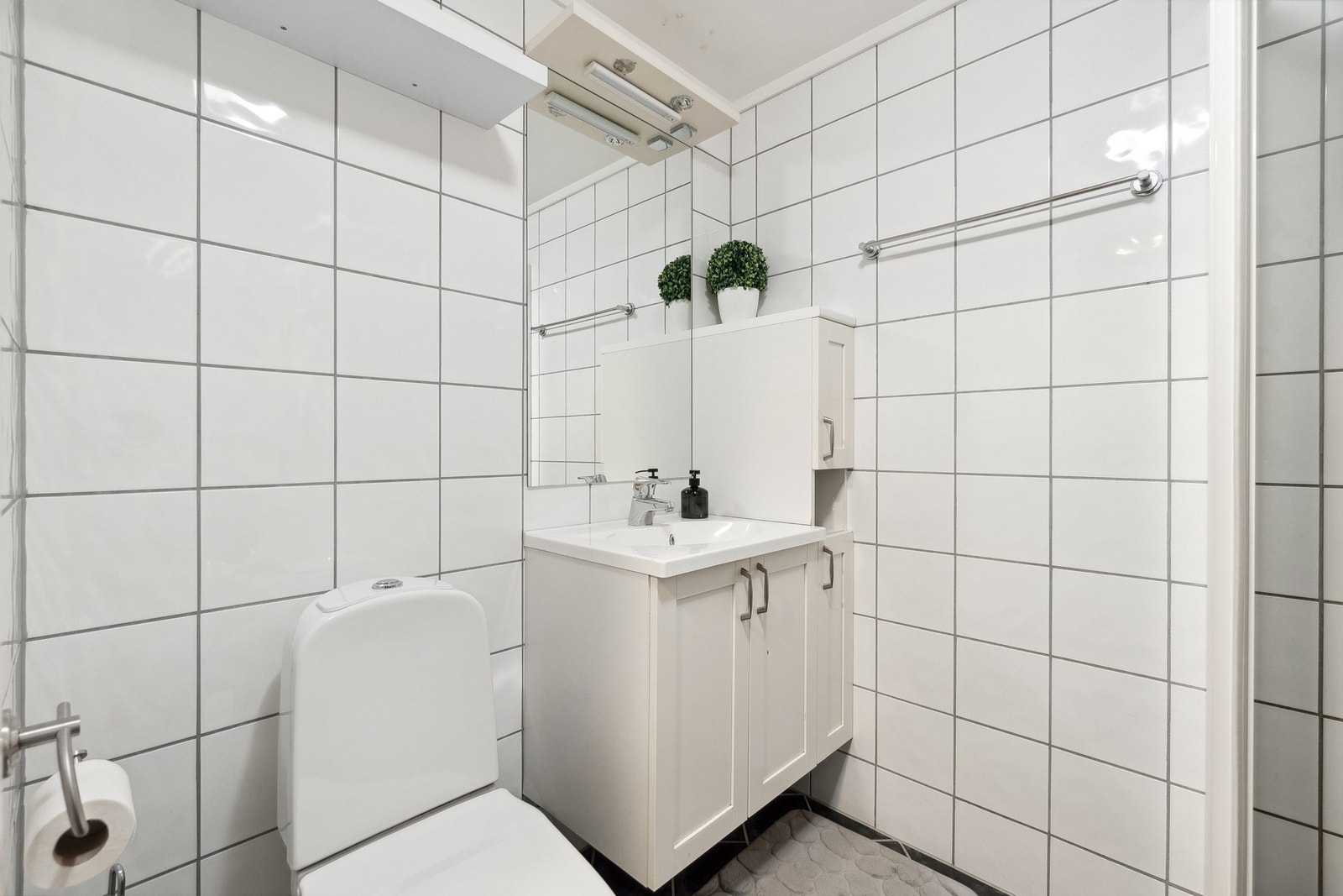 Badet har tidløse fliser på gulv og vegger. Galleribilde