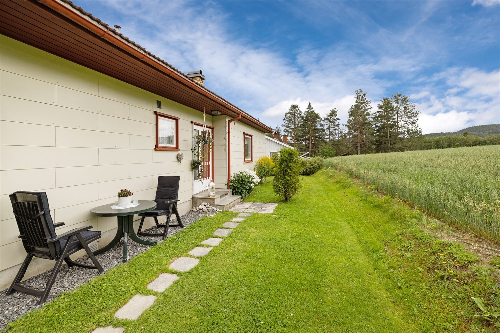 Koselig inngangsparti med steinlagt sti frem til ytterdør. Galleribilde