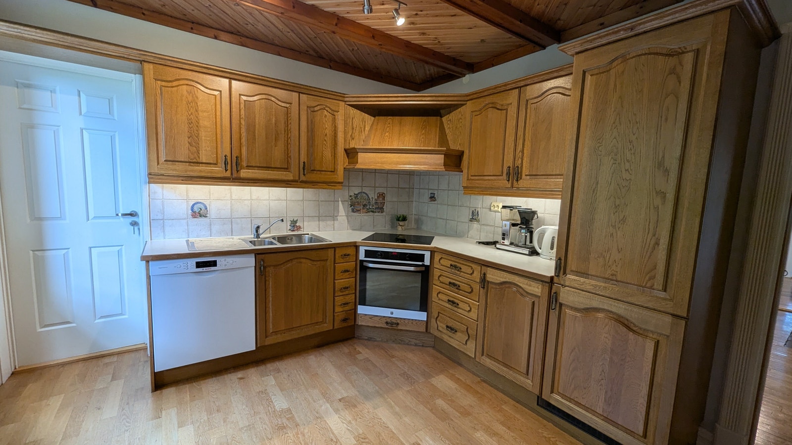 Kjøkken med integrert kjøleskap, komfyr og oppvaskmaskin Galleribilde