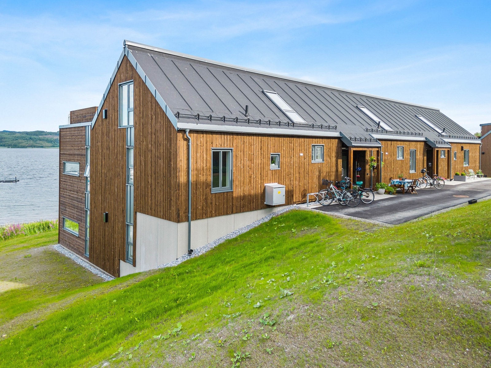 Inngangsparti til leiligheten som ligger på bakkeplan i sjøkanten. Galleribilde