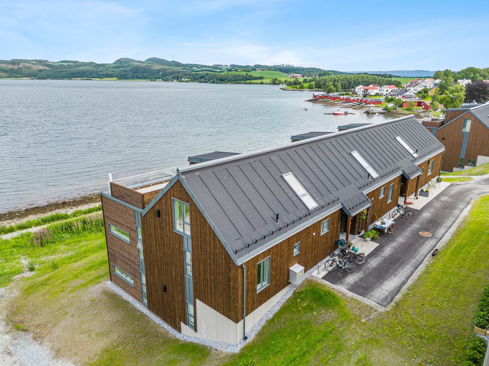 Inngangsparti til leiligheten som ligger midt i bygge på bakkeplan. Her er sjøen nærmeste nabo! Galleribilde