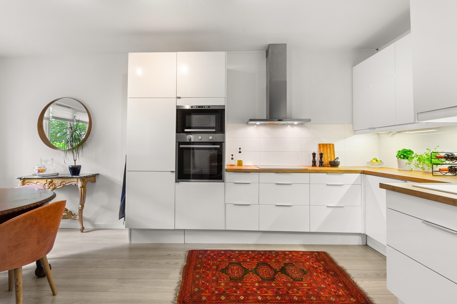 Kjøkken. Benkeplater av heltre, flislagt backsplash og slette fronter. Det er integrerte hvitevarer og oppvaskmaskin. Galleribilde