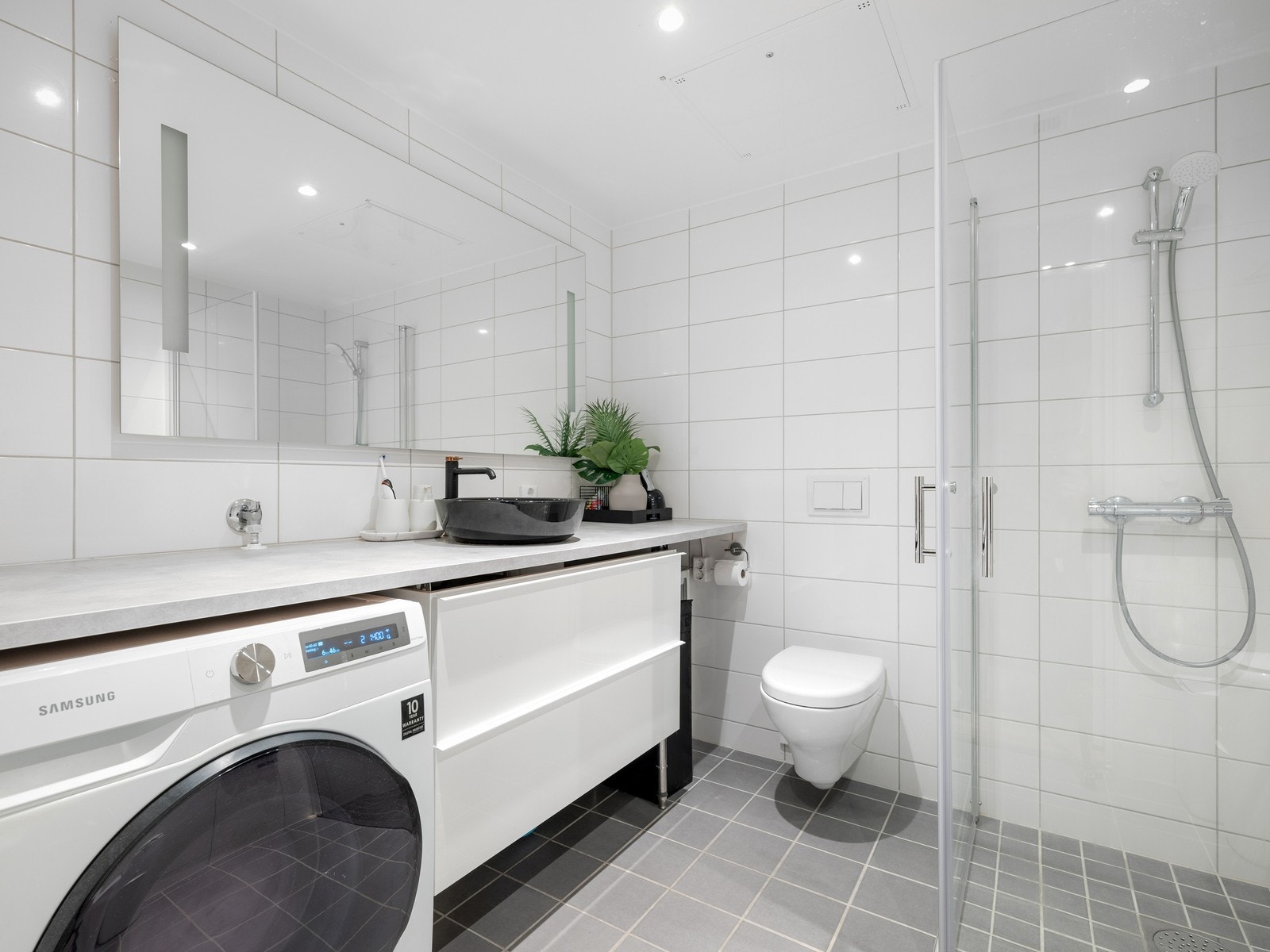 Moderne flislagt hovedbad med gulvvarme og opplegg for maskiner. Galleribilde
