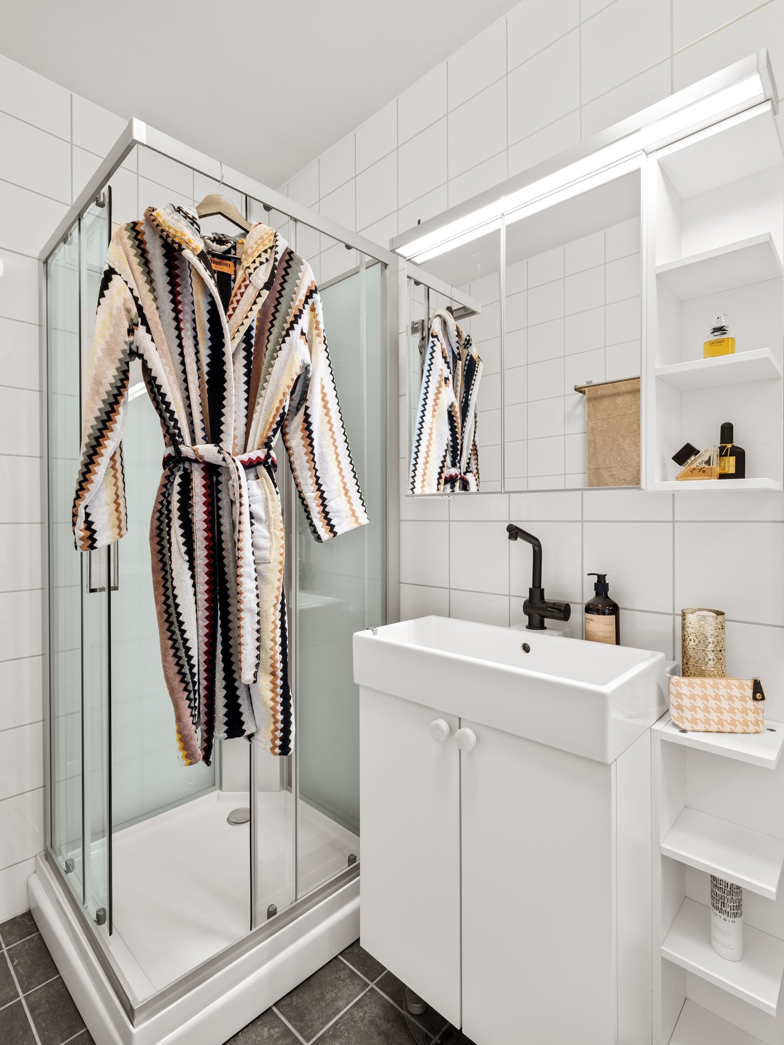 Badet er utstyrt med gulvvarme, dusjkabinett, toalett og opplegg for påkobling av vaskemaskin. Dusjkabinettet og toalett er byttet i mai 2024. Galleribilde