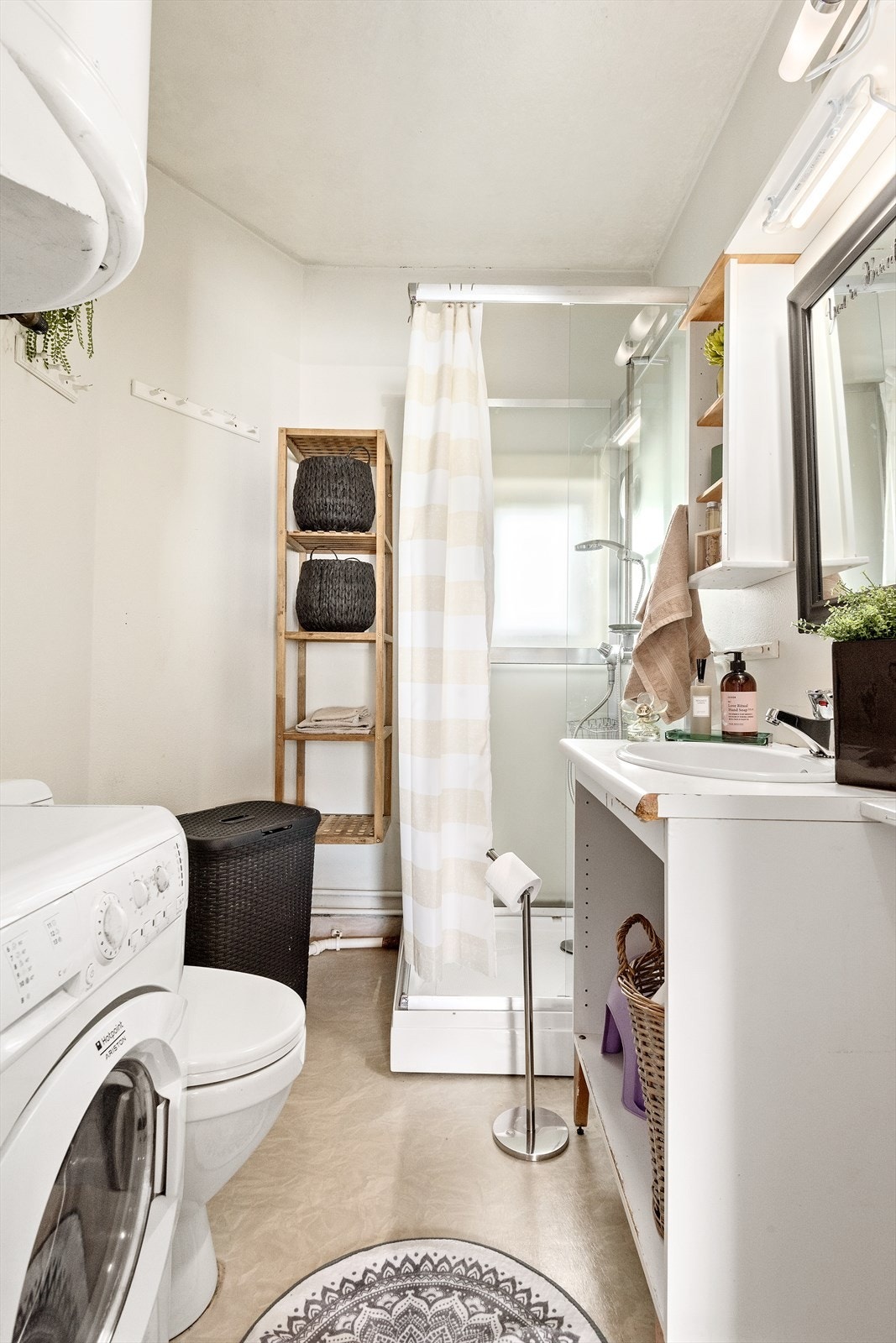 Badet er av eldre dato og har behov for oppgradering. Her finner du gulvmontert toalett. opplegg for vaskemaskin, vegghengt varmtvannsbereder, dusjkabinett og enkel servantinnredning. Galleribilde