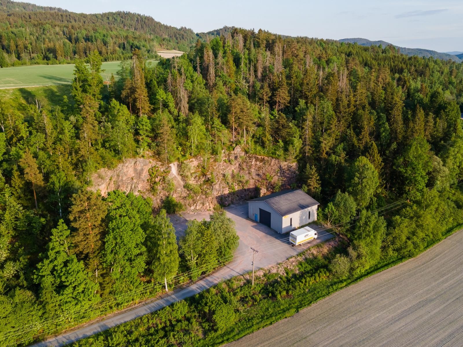 I den ene enden av eiendommen er det et lagerbygg på en asfaltert plass. Oppført ca. 2007 med automatisk leddport. Skogen rundt denne plassen og jordet i bakkant tilhører gården. Galleribilde