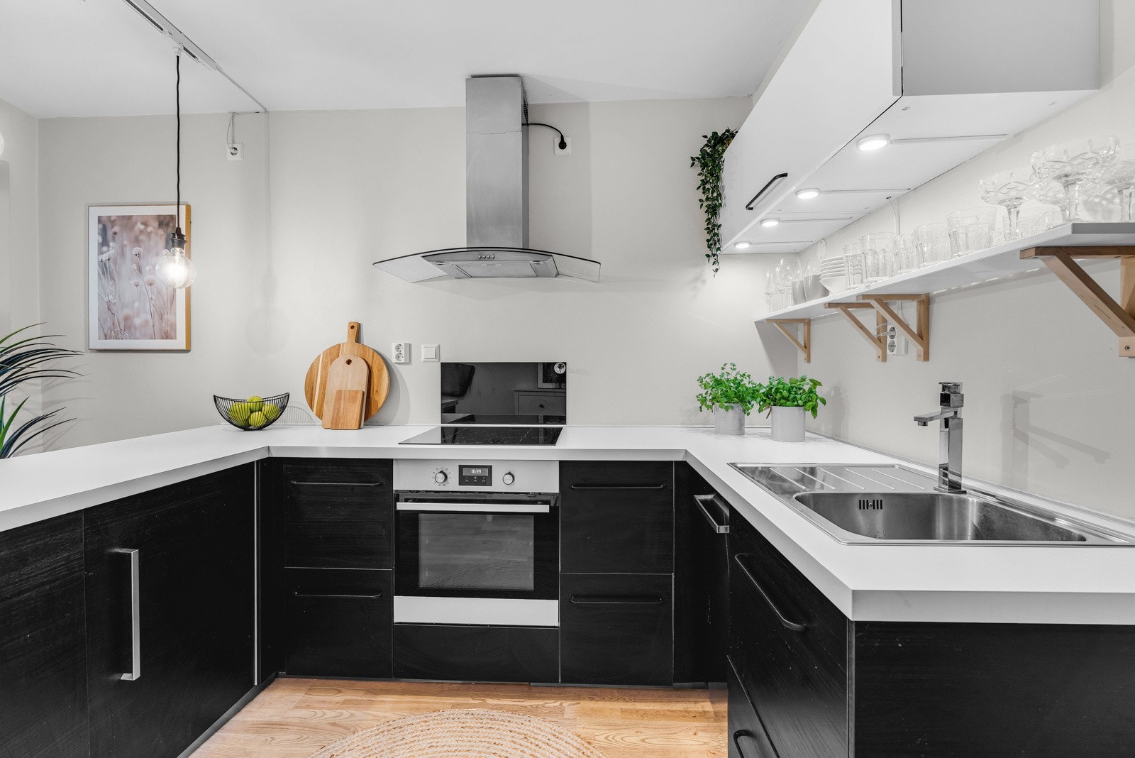 Innredning er sort, og byr på godt med skap og benkeplass. Overskapene er kun plassert på veggen mot badet. Galleribilde