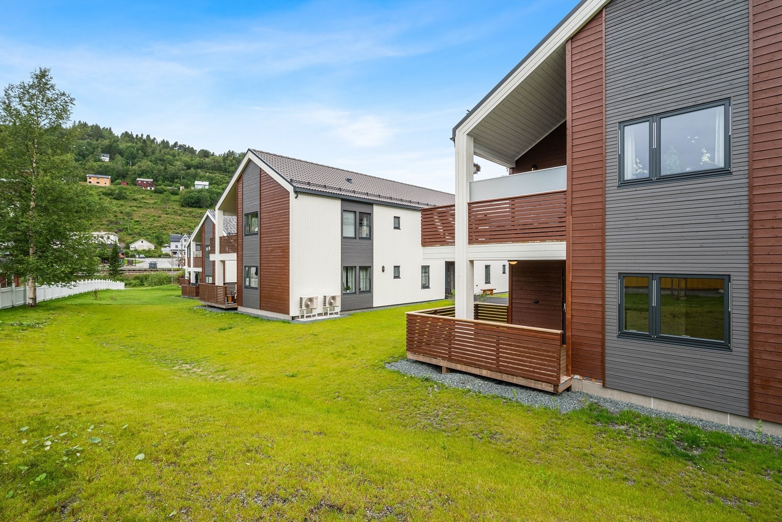 Utenfor leiligheten er det pent opparbeidet med flotte plenarealer og asfalterte gangveier. Galleribilde