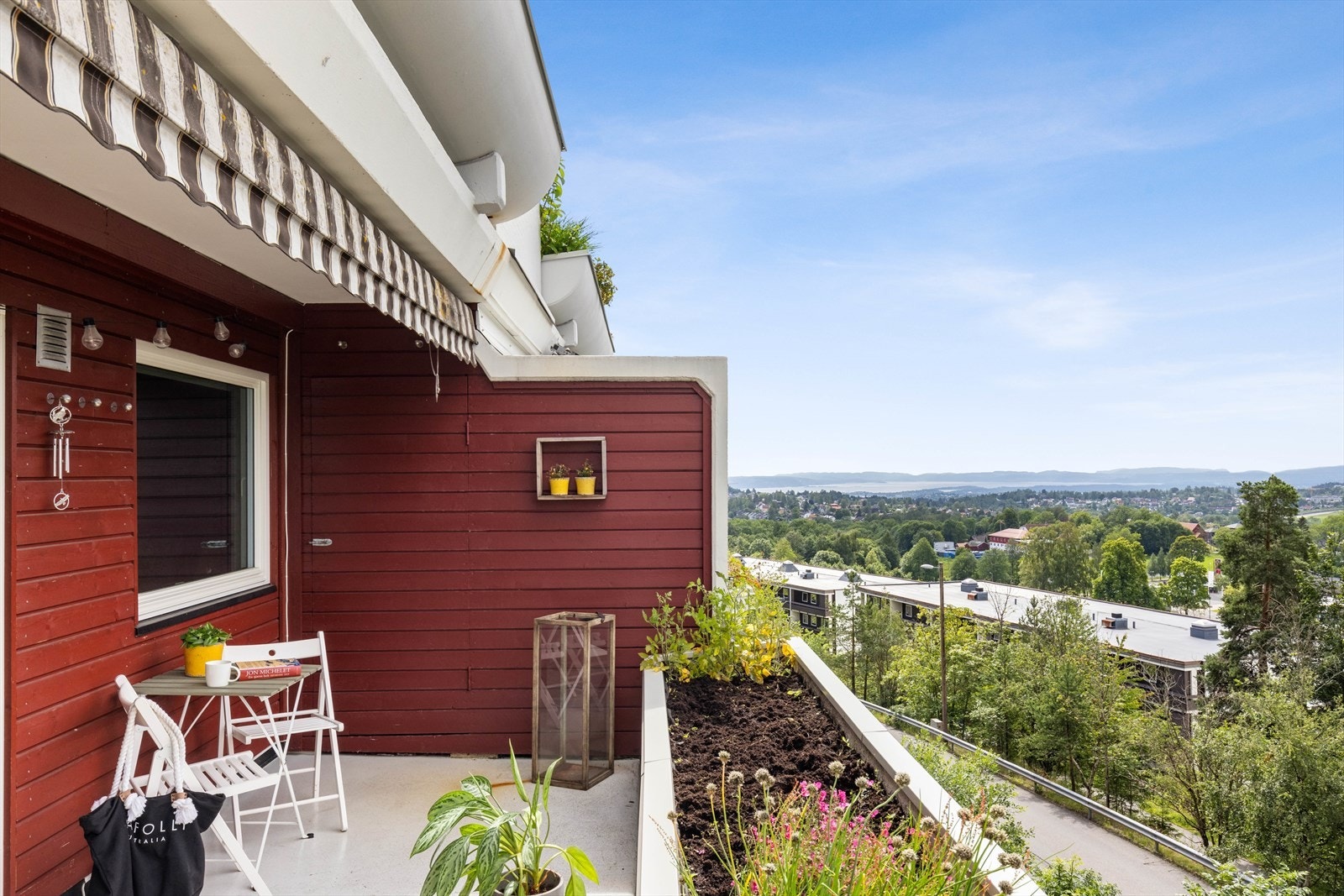 Balkongen er delvis overbygd og utstyrt med markise, blomsterkasse og bod på 2 m². Galleribilde
