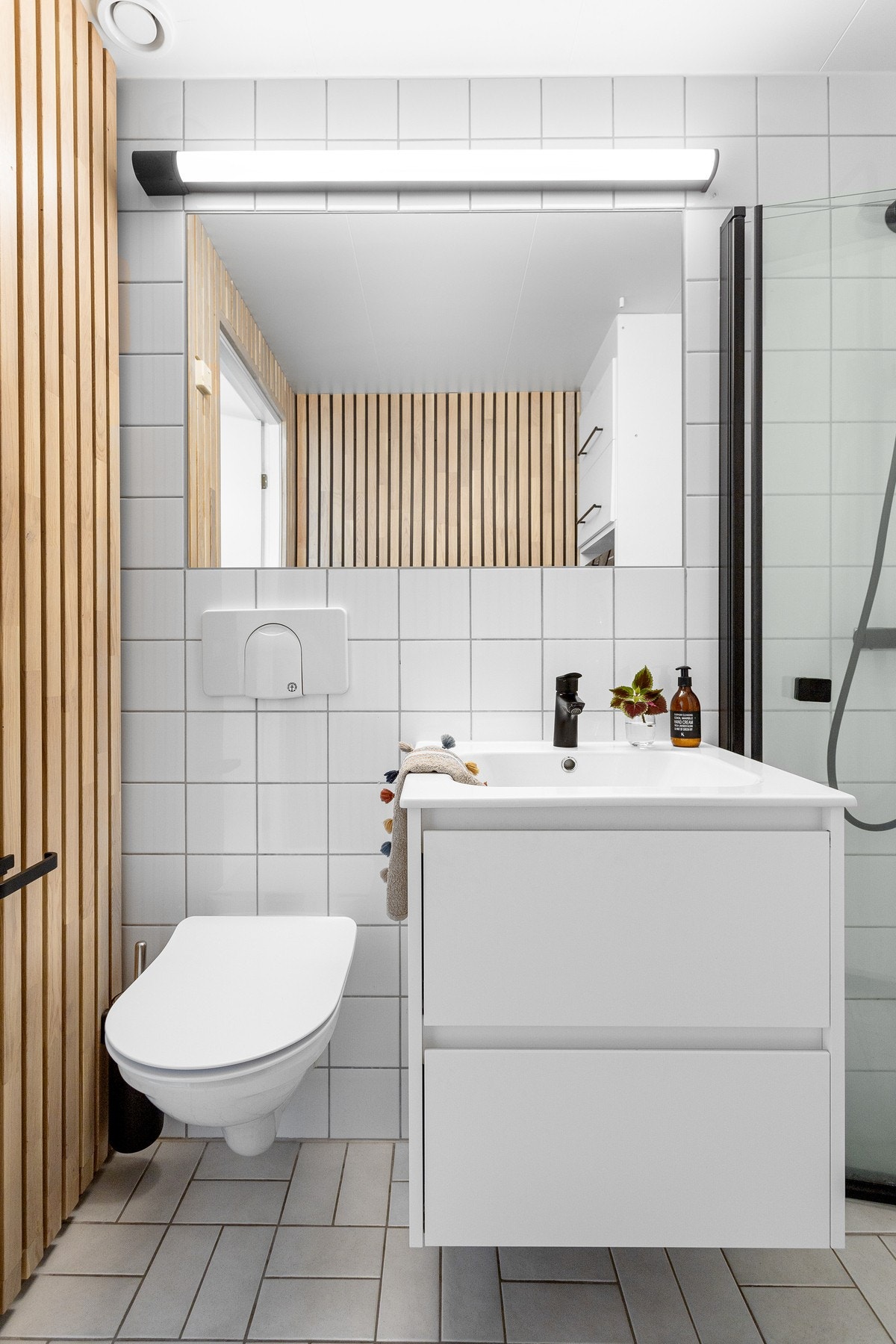 Videre har badet vegghengt toalett og dusj med innfellbare glassdører. Galleribilde