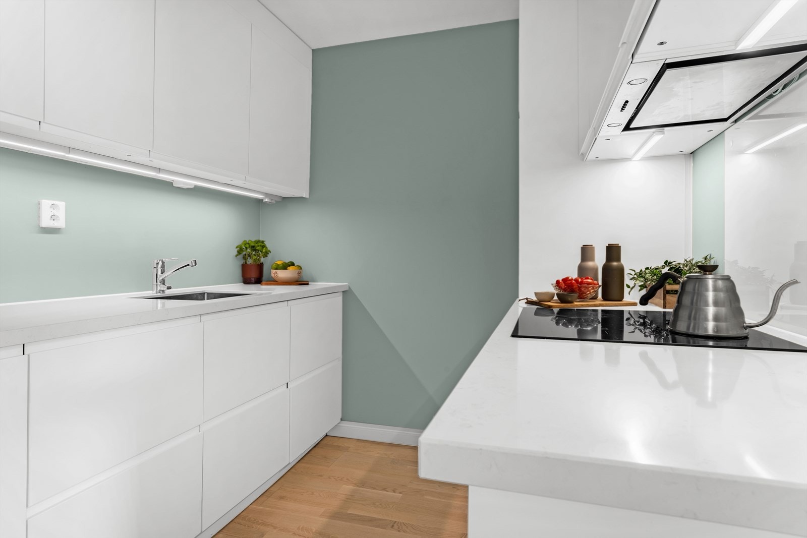 Stilrent IKEA-kjøkken fra 2018 med hvite, glatte fronter og lekker benkeplate av granitt/stein. Galleribilde