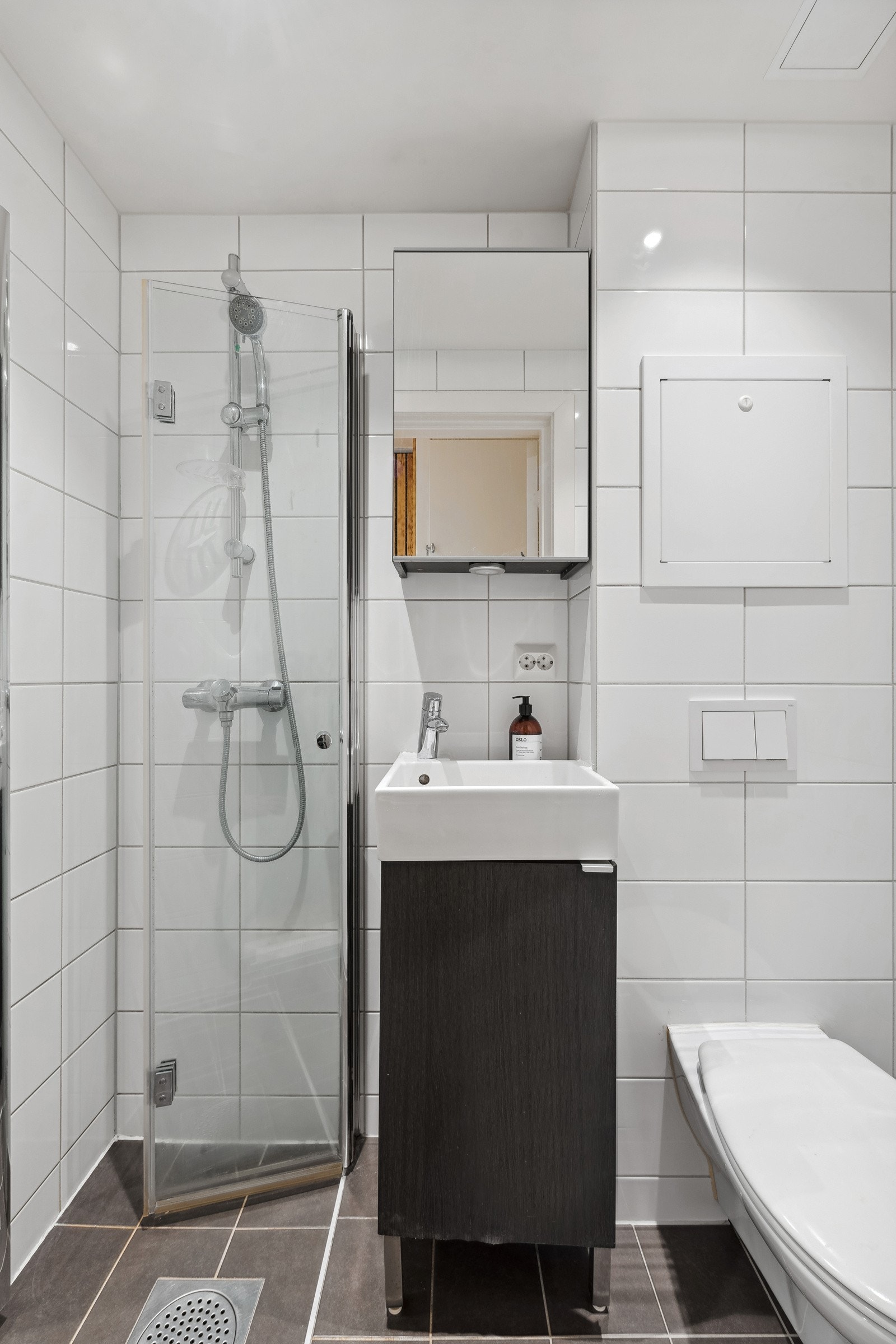 Flislagt gulv med gulvvarme og flislagte vegger. Nedsenket himling med downlights og malt flate. Galleribilde