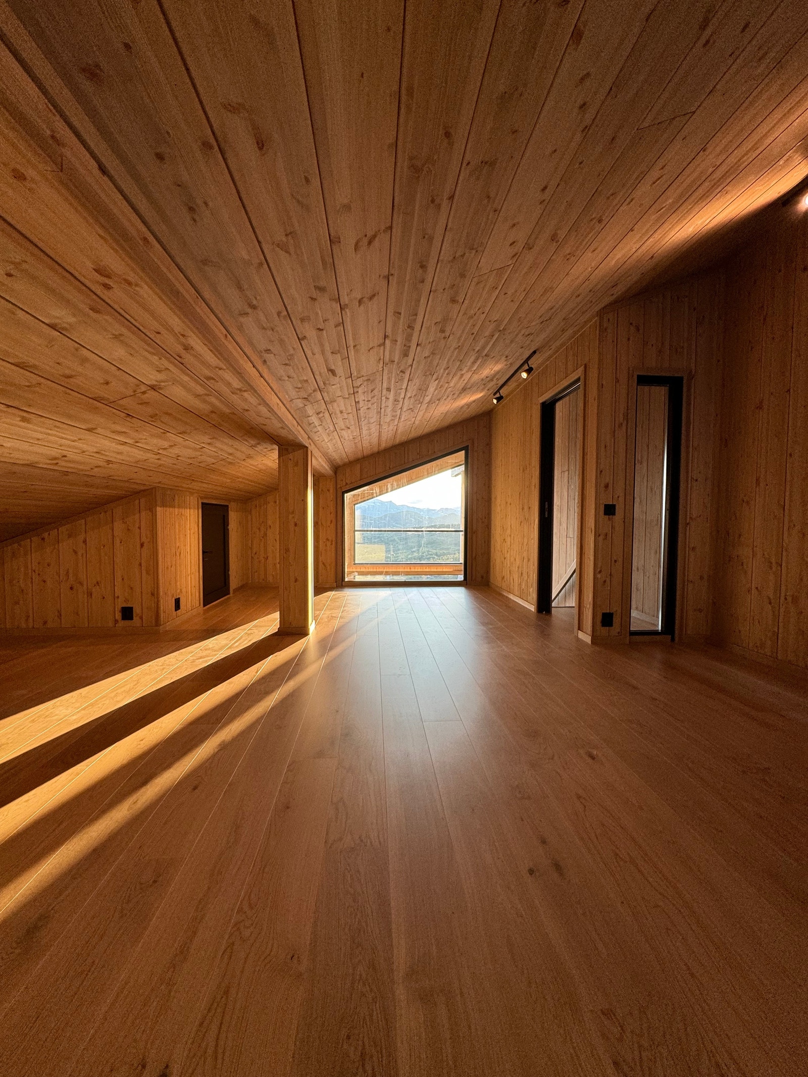 Loftstue-perspektiv, eikeparkett og beiset limtrepanel på veggene Galleribilde