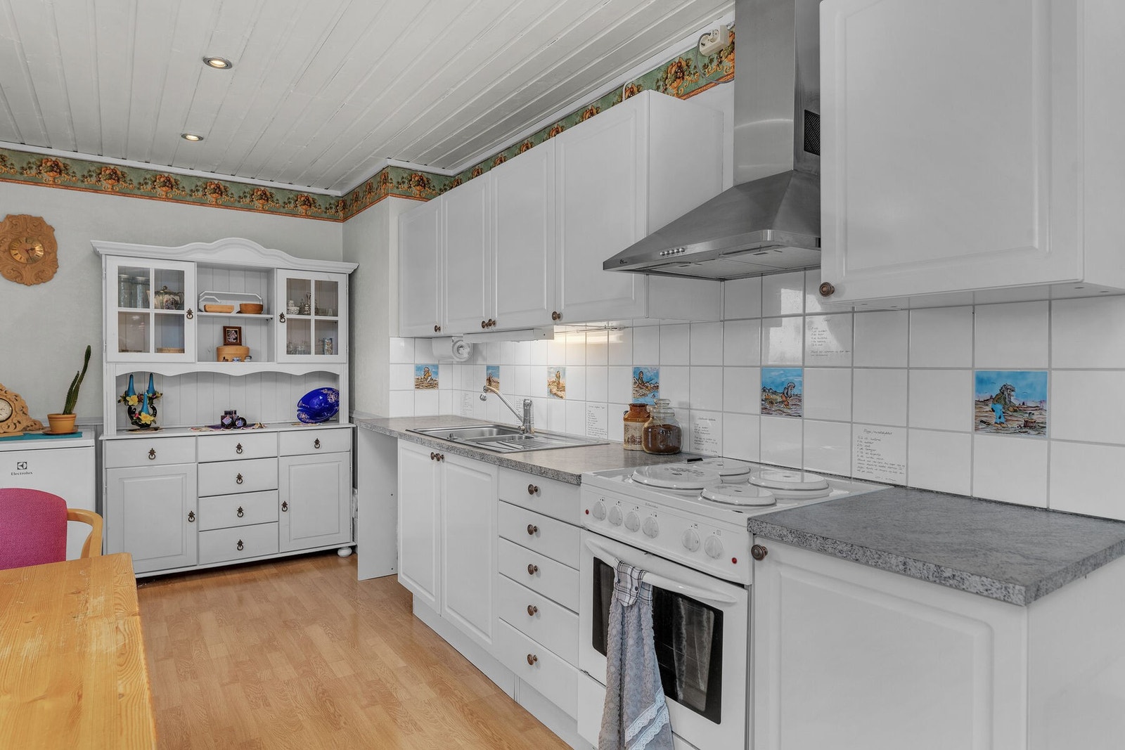 Kjøkkenet har profilerte fronter og opplegg for frittstående hvitevarer Galleribilde