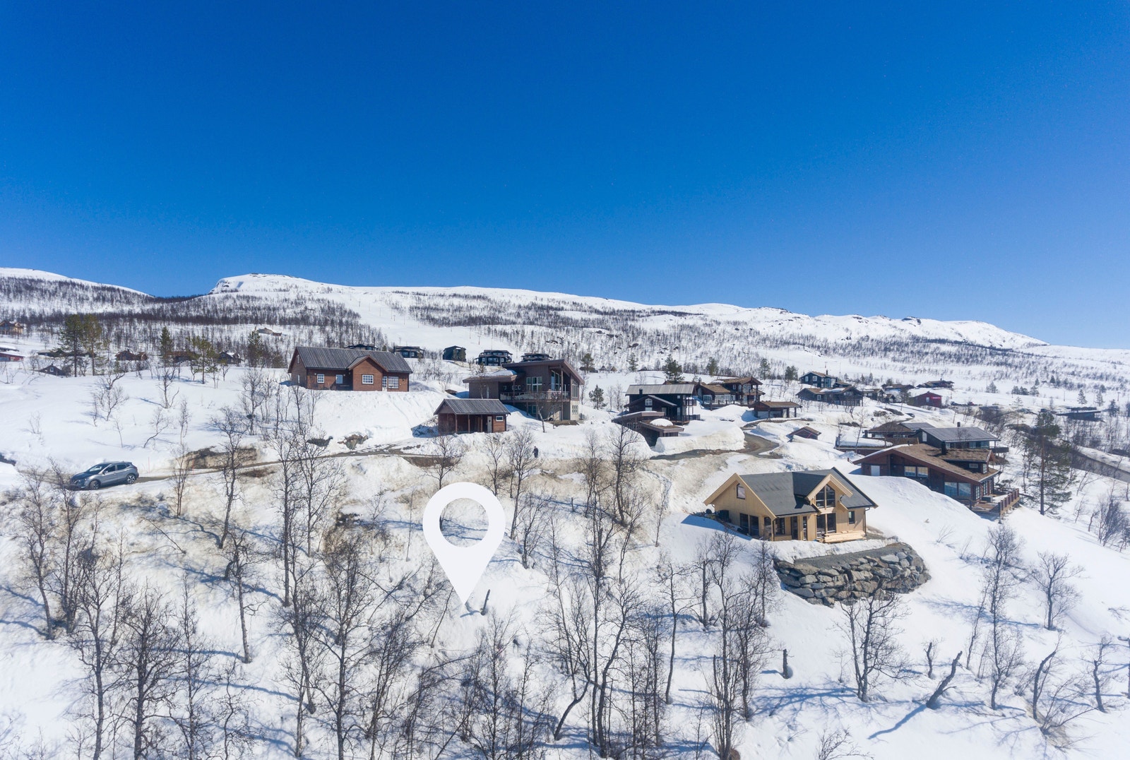 Tomta er 1062,9 kvm stor med flott plassering høyt oppe i fjellandsbyen og fantastisk utsikt Galleribilde
