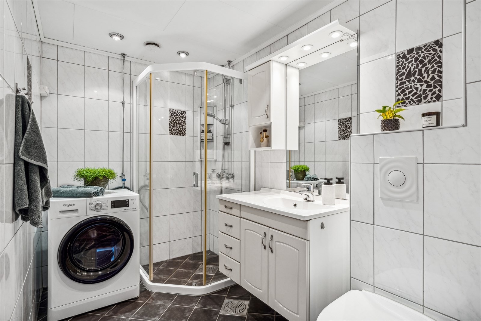 Badet er flislagt med varmekabler for ekstra komfort, rehabilitert i regi av borettslaget 2005. Det er opplegg og plass for vaskemaskin og tørketrommel. Galleribilde