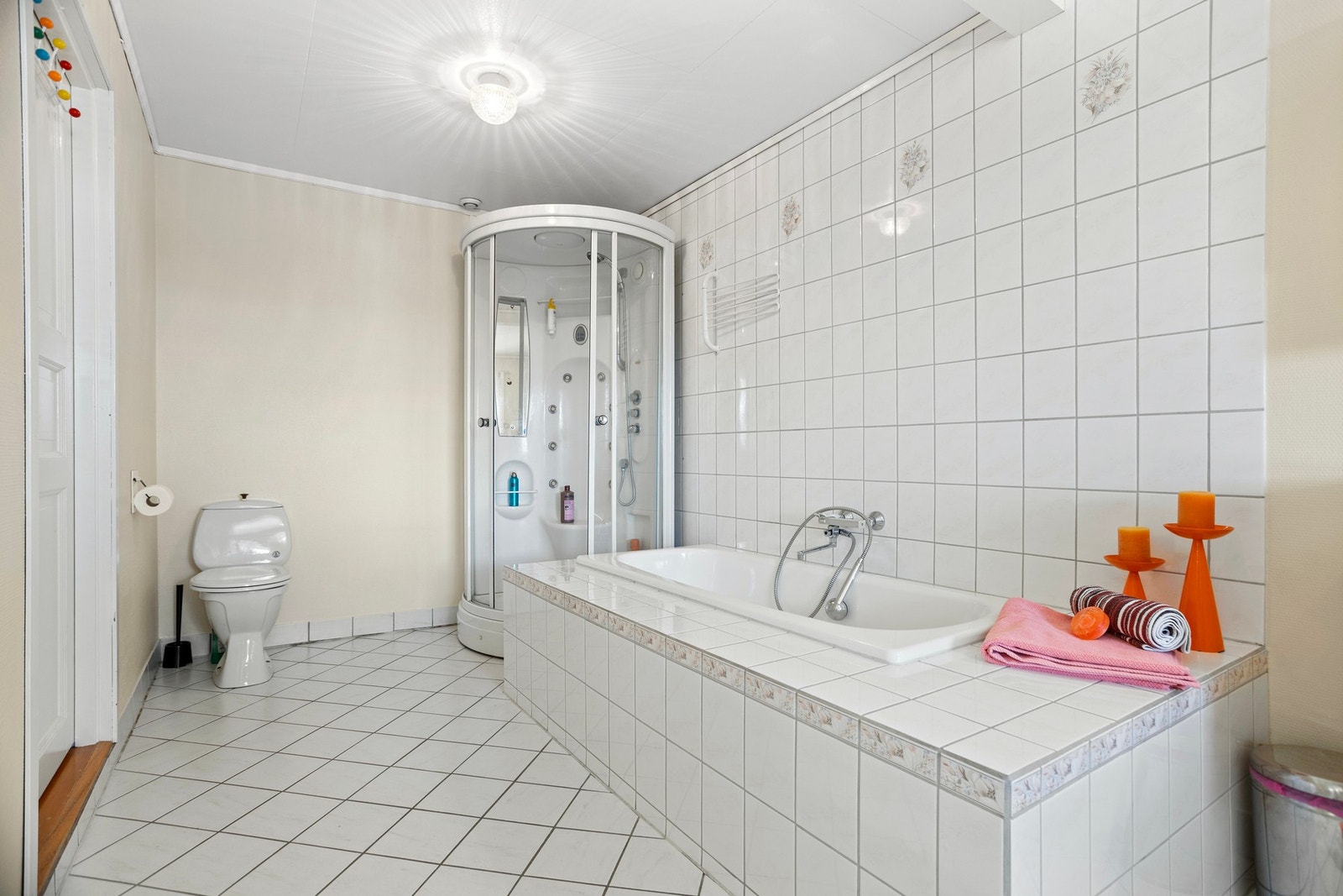 Badet er av god størrelse og er utstyrt med dusjkabinett, toalett, badekar og servantskap Galleribilde