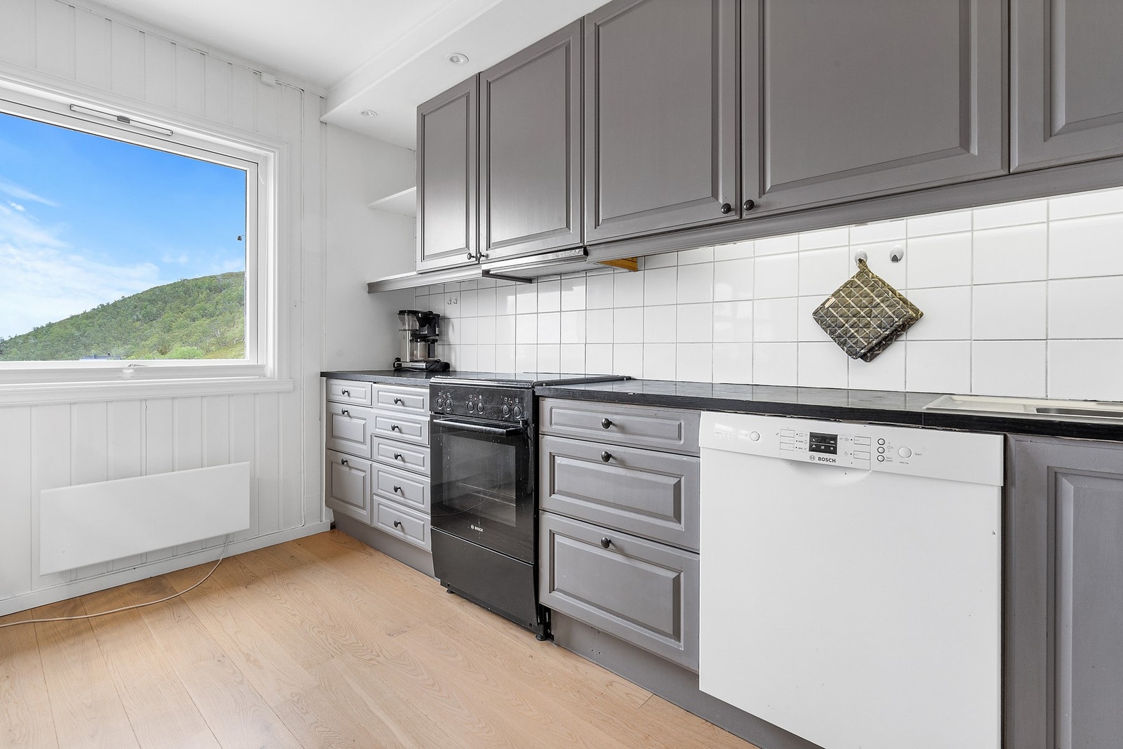 Kjøkkenet har innredning med glatte fronter og benkeplaten er av laminat. Galleribilde
