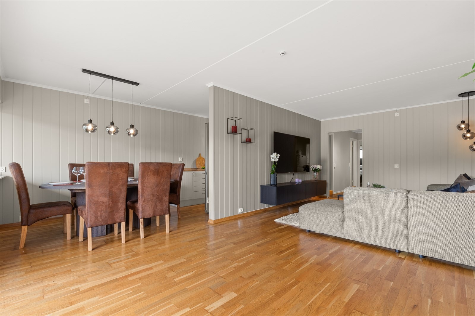 Stuen ligger i en delvis åpen løsning med kjøkkenet, men arbeidssonen er godt skjermet. Galleribilde