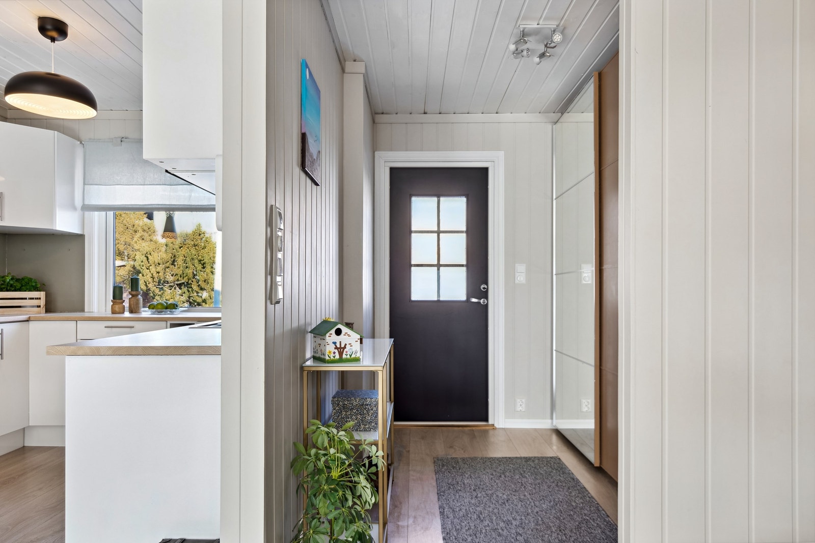 Lys og pen entré med skyvedørsgarderobe. Galleribilde