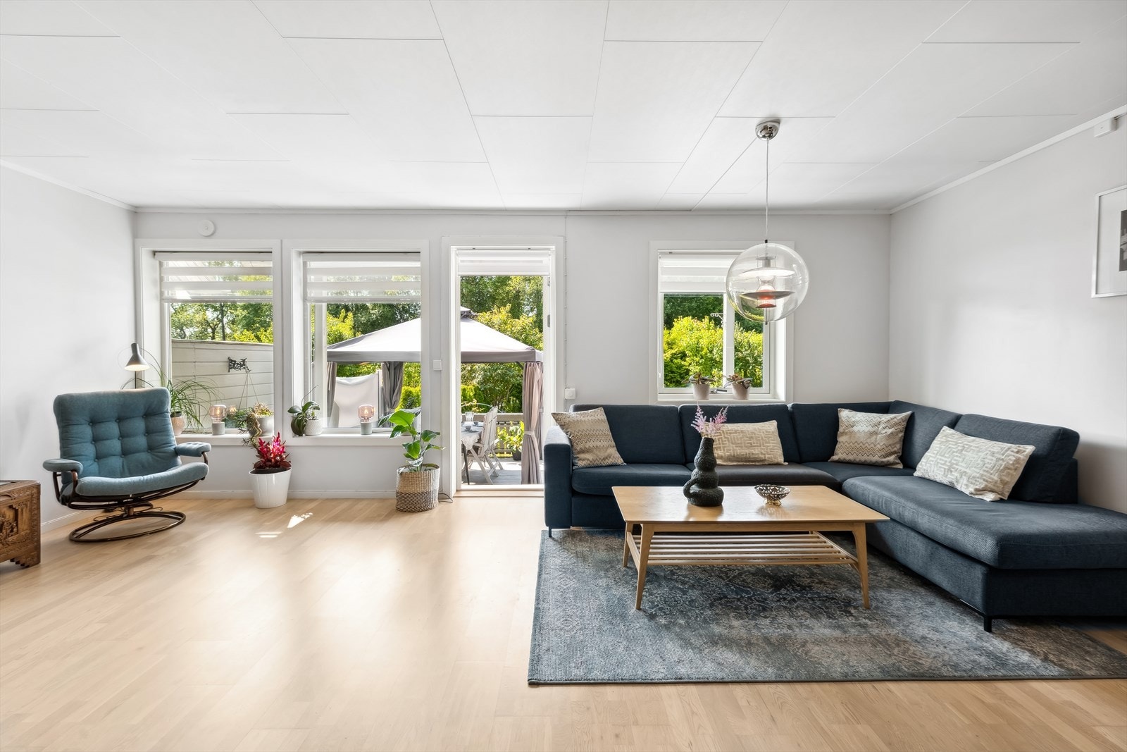 Moderne og stilfull innredning i stuen med direkte tilgang til den solrike terrassen. Galleribilde