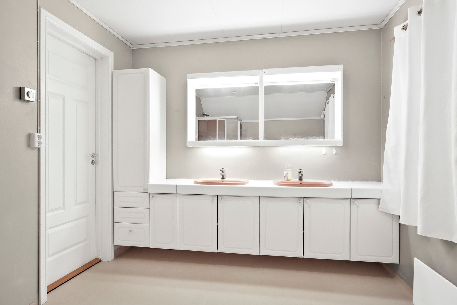 Badet har en vegghengt servantinnredning med skuffer og dører, og dobbel ovenpåliggende servant Galleribilde