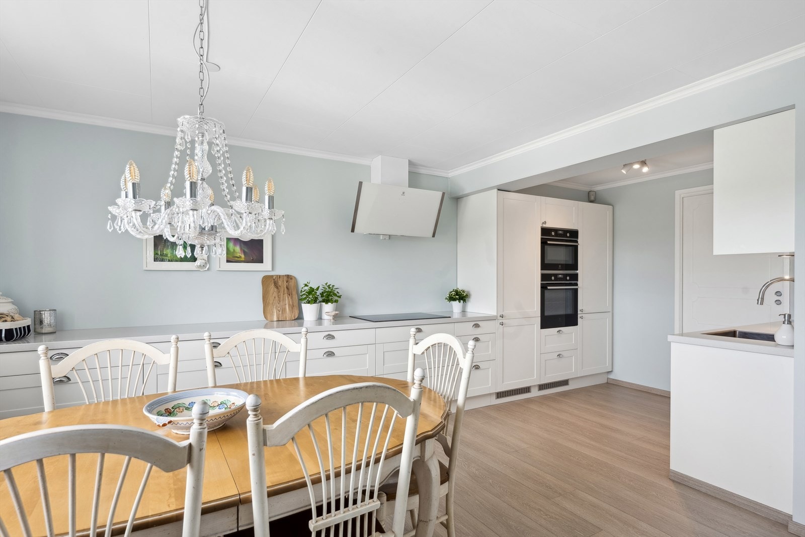 Pen kjøkkeninnredning fra 2021 med benkeplate i komposittsten og integrerte hvitevarer: Komfyr, kombiovn (stekeovn og komfyr), oppvaskmaskin, induksjontopp, kjøl- og fryseskap, samt ventialtor med avtrekk ut. Galleribilde