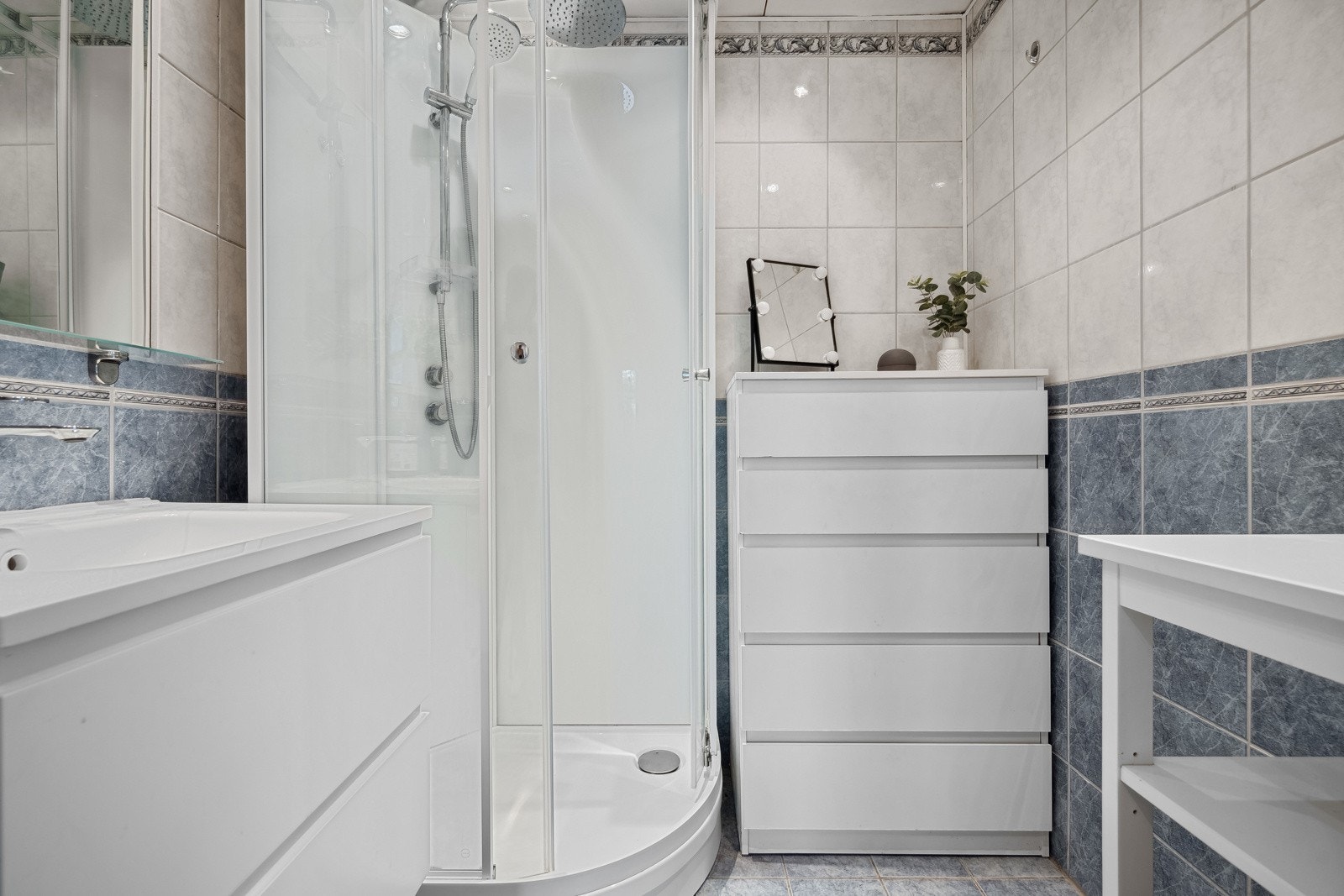 Flislagt baderom med elektrisk gulvvarme og innfelte downlights i himling. Nytt dusjkabinett Galleribilde