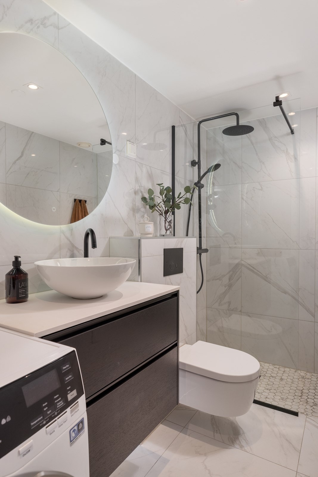 Delikate farge- og materialvalg går igjen i hele leiligheten, og badet er inget unntak. Galleribilde