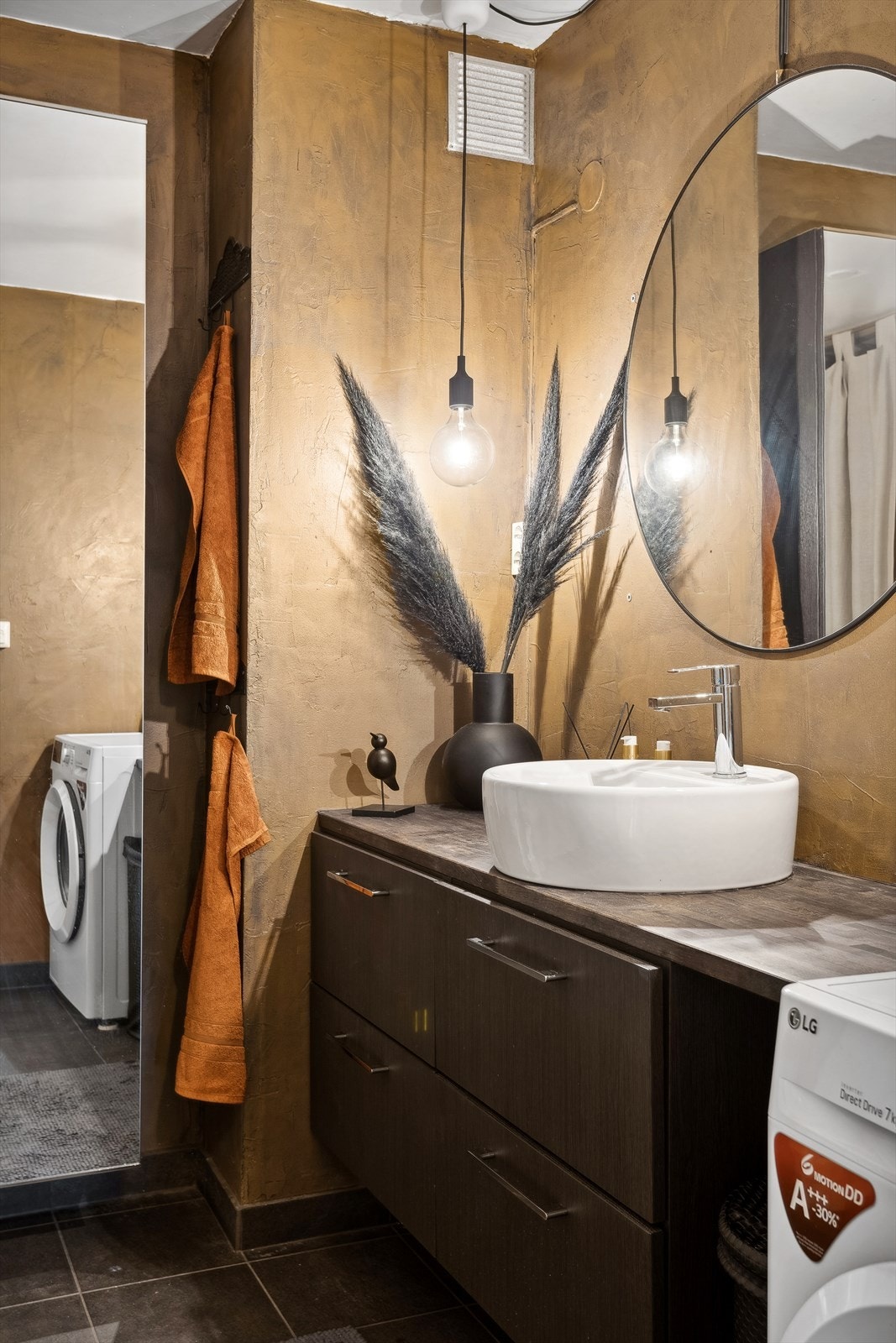 Badet består av servant med tilhørende skuffer, speil, toalett, badekar, speilskapet og det er opplegg for vaskemaskin. Galleribilde
