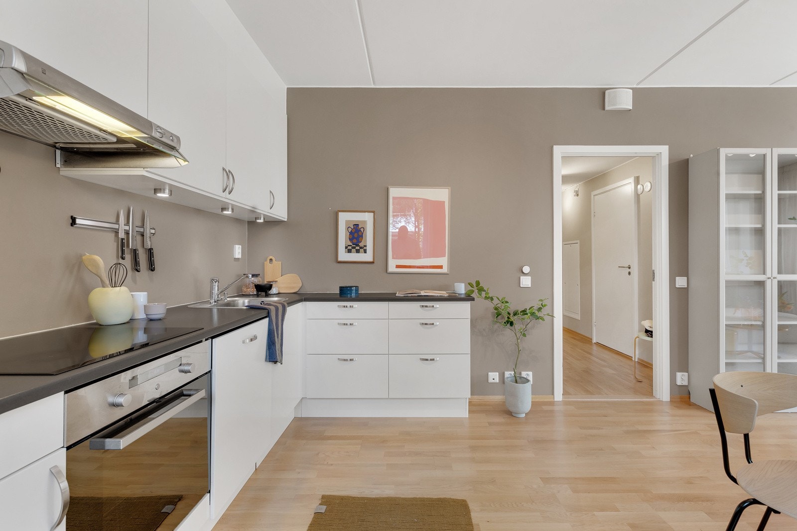 Du har god skap- og benkeplass i innredningen som har hvite glatte fronter og laminert benkeplate med nedsenket oppvaskkum. Galleribilde