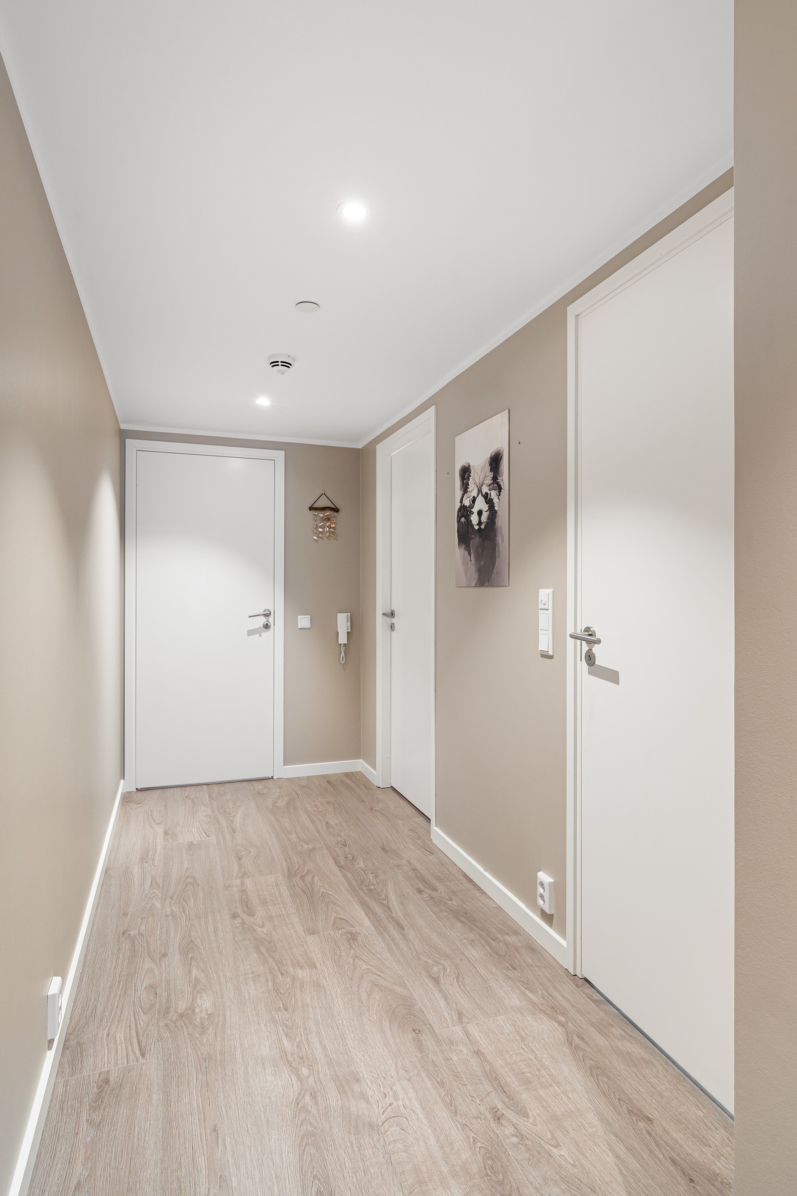 Velkommen inn! Entreen har plass for både sko og yttertøy. Leiligheten framstår moderne med lyse farger og fine materialvalg. Galleribilde