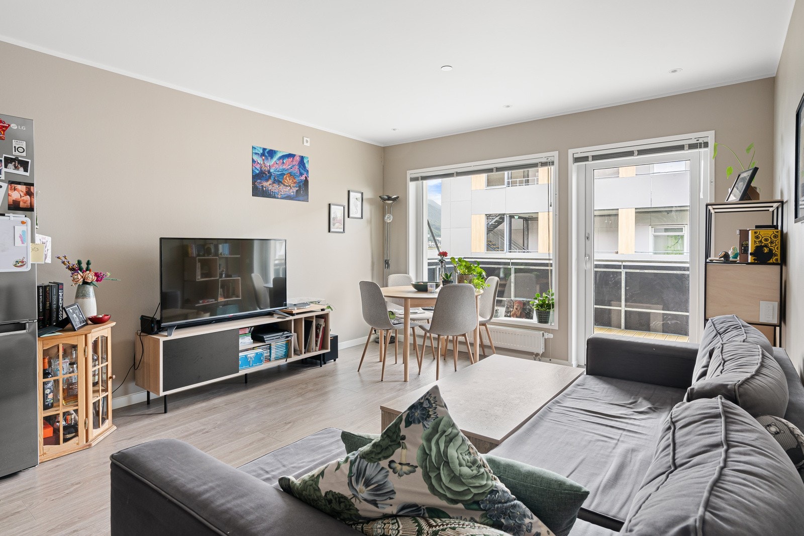 Lys stue med store vindusflater som sikrer rikelig med naturlig lys inn i leiligheten. Det er lagt nytt gulv i leiligheten i 2021. Galleribilde