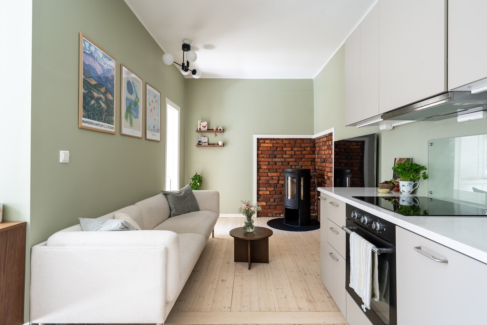 Forbi kjøkkenet er det innredet en koselig TV-krok sentrert rundt peisen med plass til sofa, salongbord, tv og mediemøblement. Galleribilde