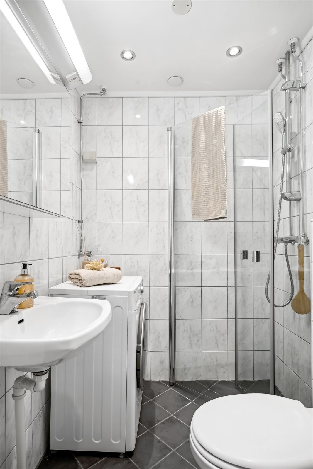 Det er i tillegg integrert belysning i taket, og dusjhjørne med innsvingbare glassdører. Det er opplegg for vaskemaskin. Galleribilde