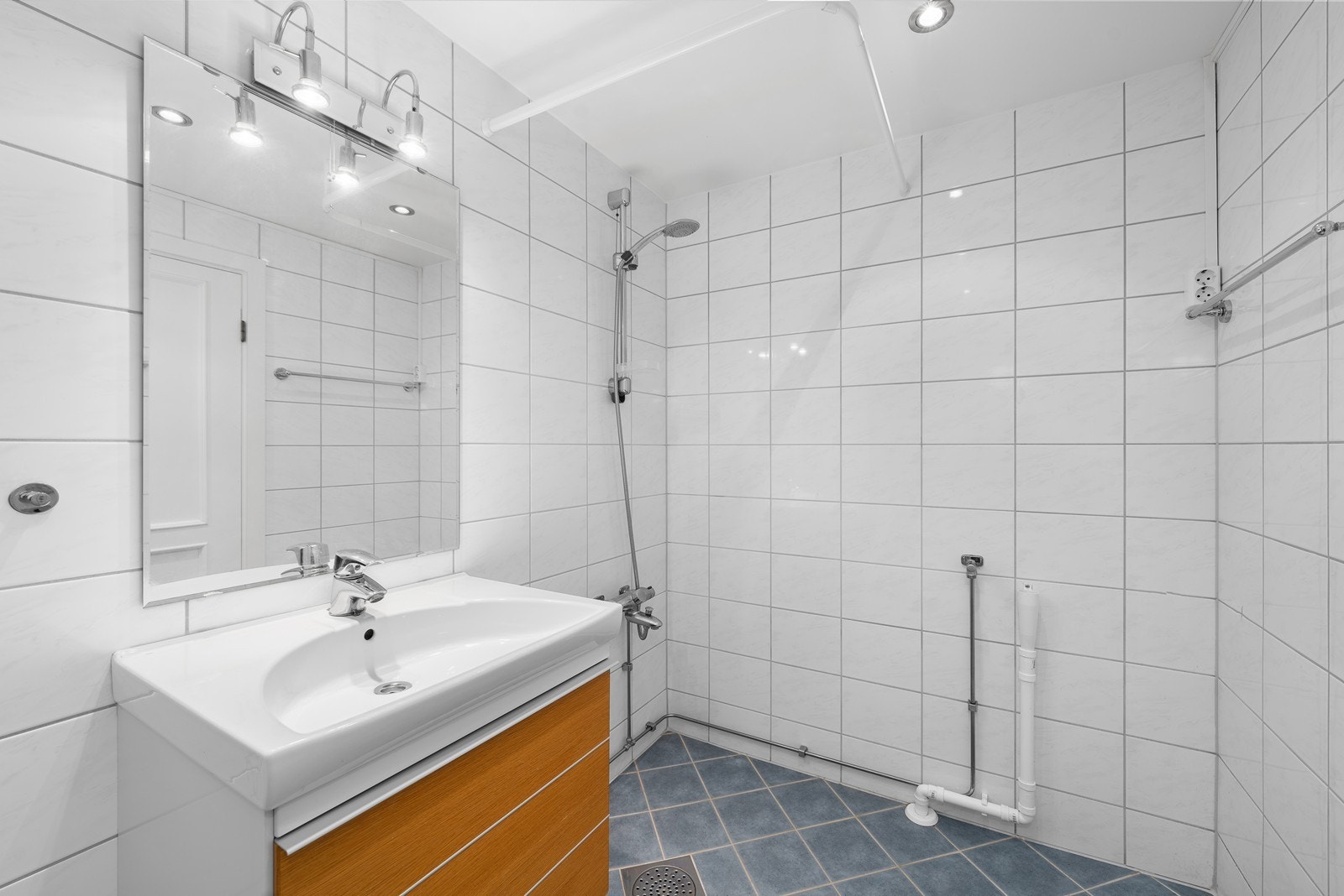 Flislagt bad med varmekabler i gulvet og downlights i taket. Galleribilde