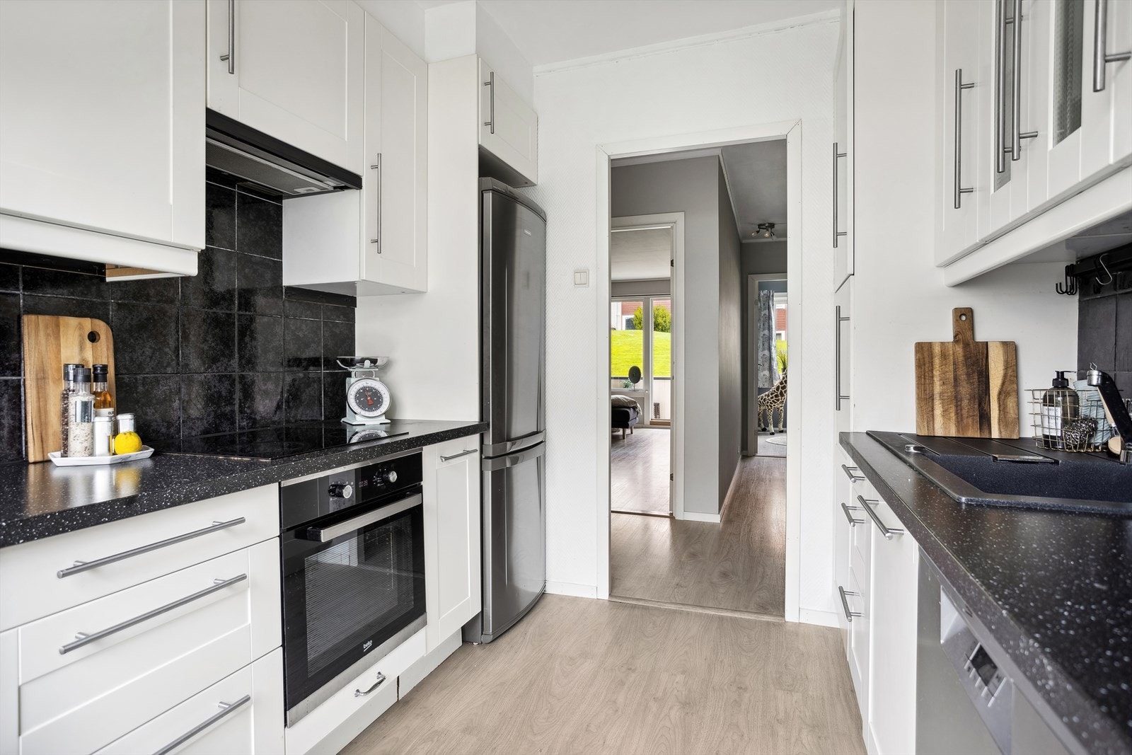 Kjøkkenet er innredet med platetopp, stekeovn, oppvaskmaskin og kjøleskap. Galleribilde