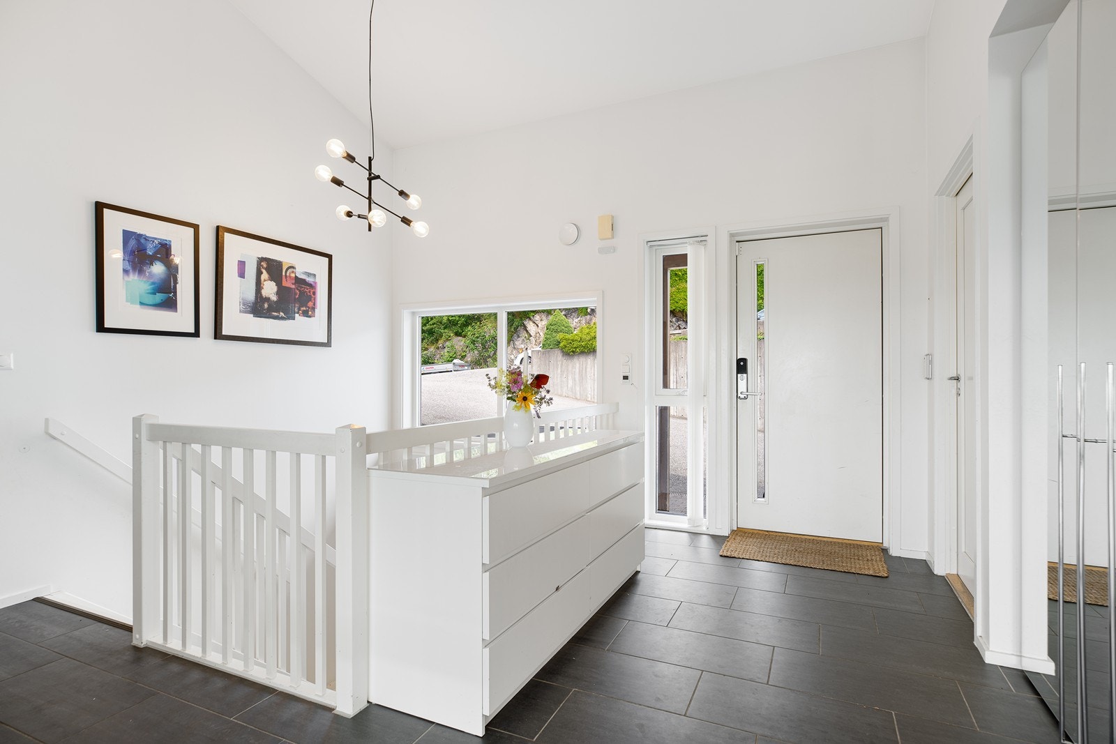 En meget flott gang med god takhøyde. Skifer på gulv og lyse farger på veggene Galleribilde