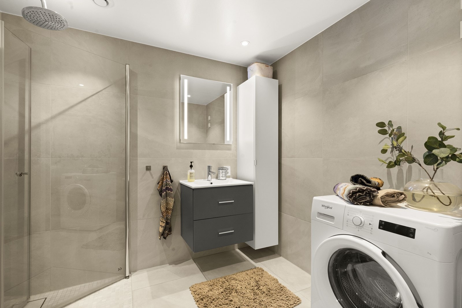 Lekkert flislagt bad fra byggeåret med opplegg for vaskemaskin Galleribilde