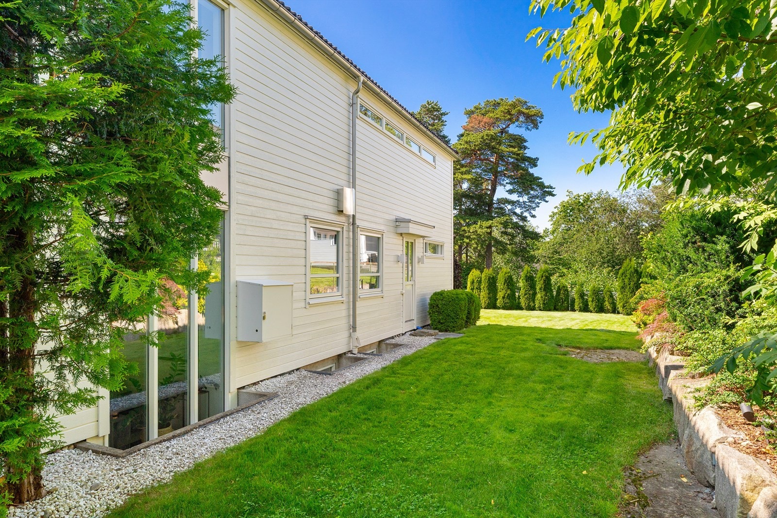 De store vindusflatene gir godt med lys både fra bakhagen og forhagen. Galleribilde