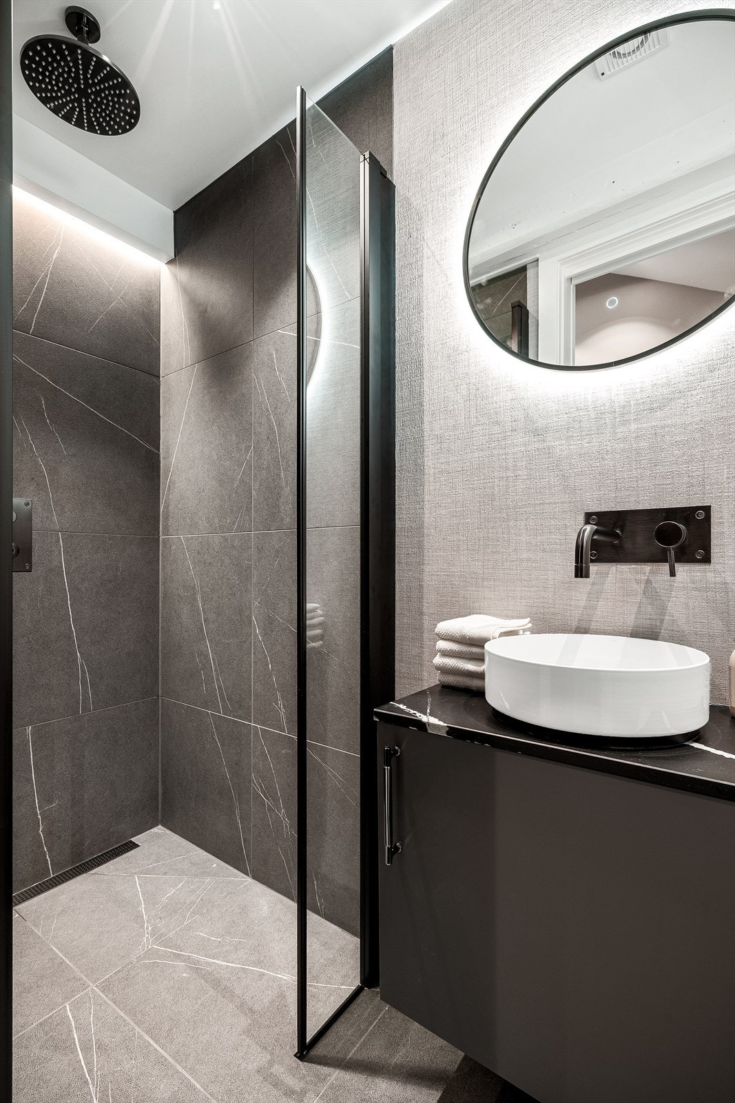 En-suite baderom med dusj, servant og vegghengt wc. Fliser og designtapet fra Élitis. Galleribilde
