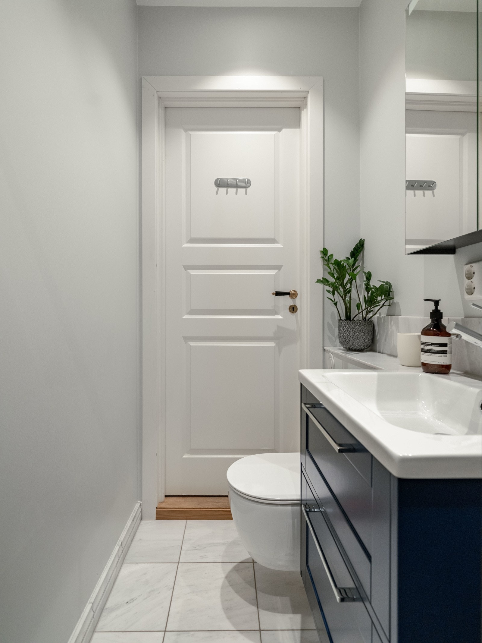 Badet er innredet med vegghengt toalett, servant med skuffinnredning, speilskap og regnfallsdusj. Det er naturligvis downlights i himling og varme i gulvet. Galleribilde