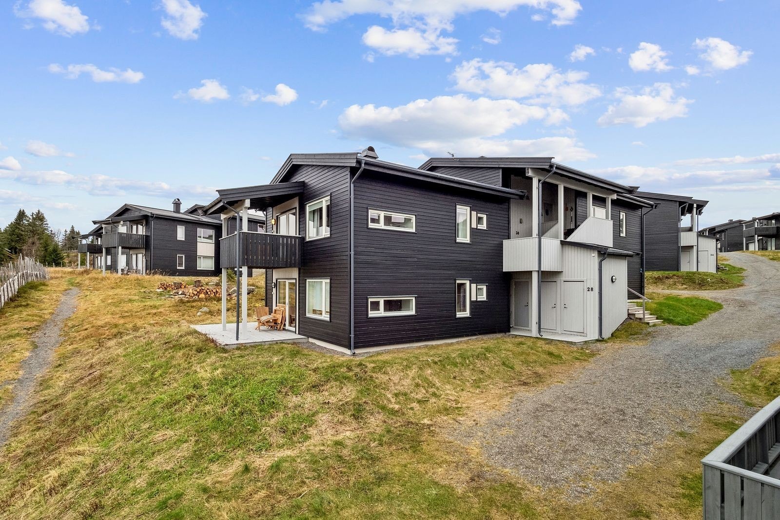 Utvendig med overbygd terrasse med utsikt ned mot Sjusjøen Galleribilde