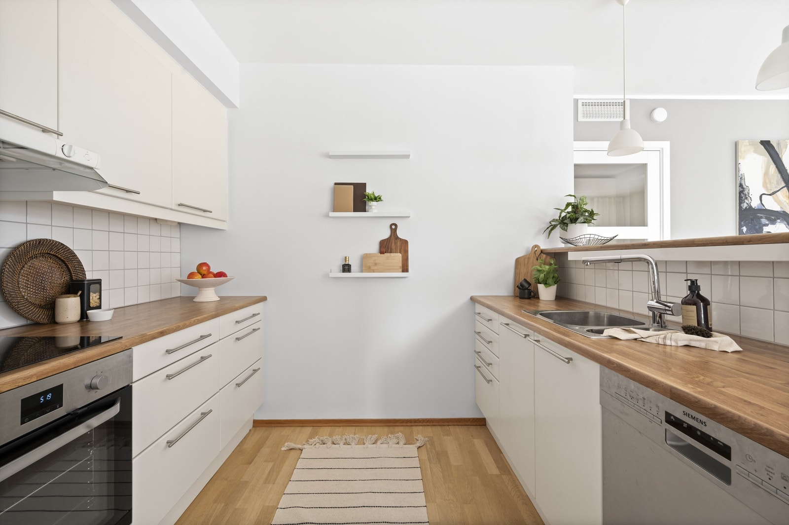 Kjøkkenet har godt med skap- og benkeplass og innredningen består av glatte fronter, heltre benkeplate med nedfelt vask- og skyllekum. Galleribilde