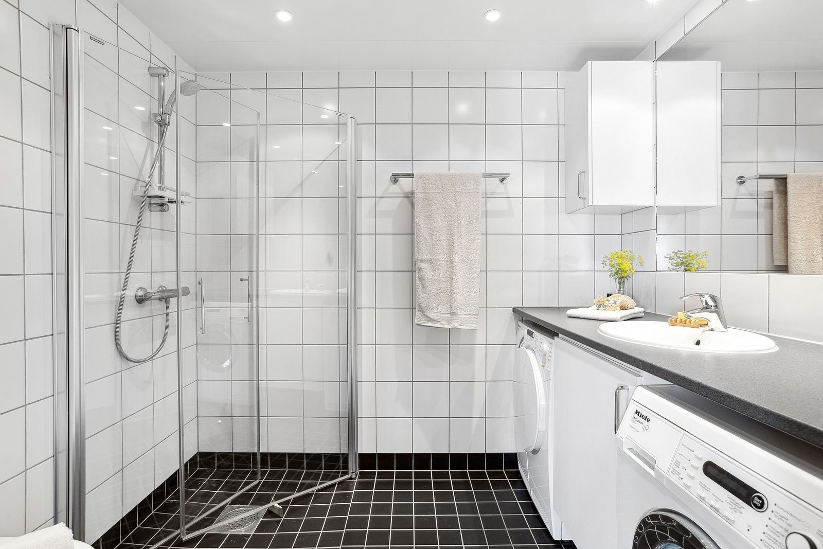 Romslig og pent flislagt bad fra 2013 med opplegg for vaskemaskin og tørketrommel. Galleribilde