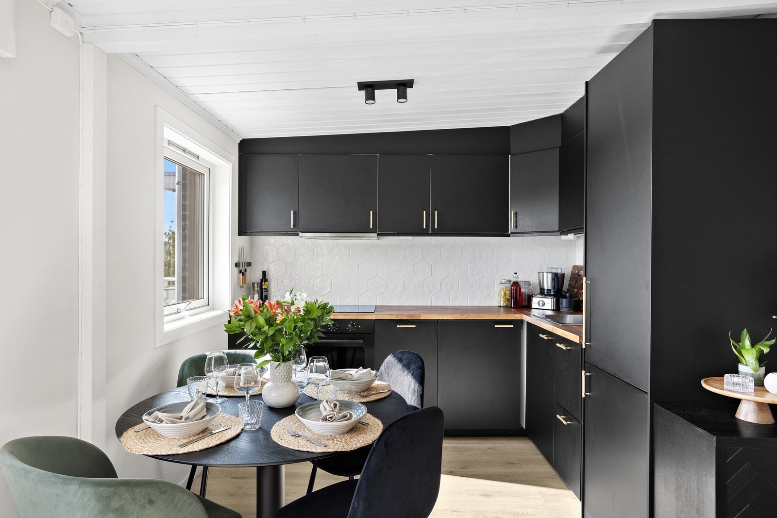 Kjøkkenet fra 2021 består av mørke slette fronter, nedfelt oppvaskkum og heltre benkeplate. Galleribilde