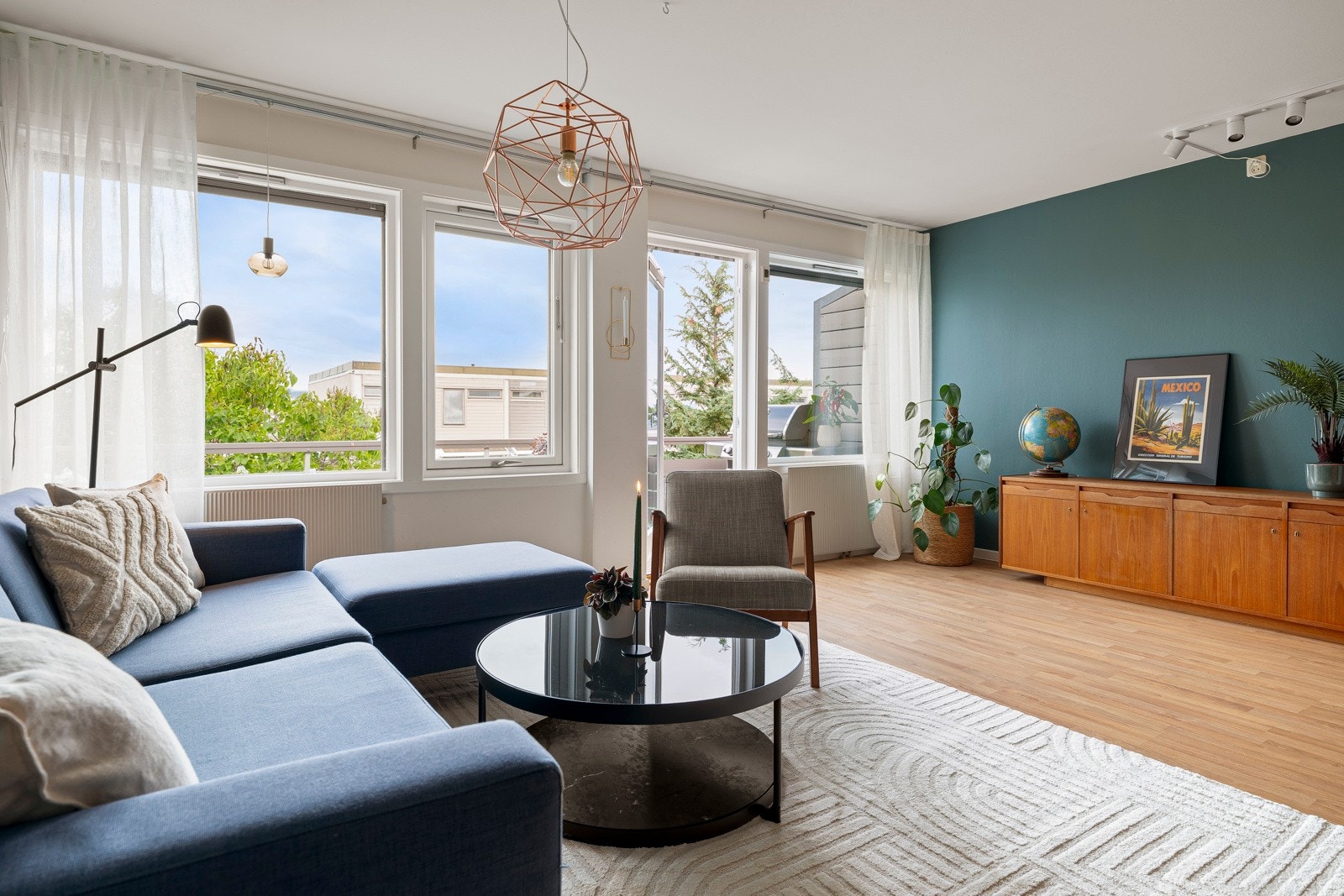 Store vindusflater sørger for rikelig med naturlig lysinnslipp og god atmosfære på stua. Galleribilde