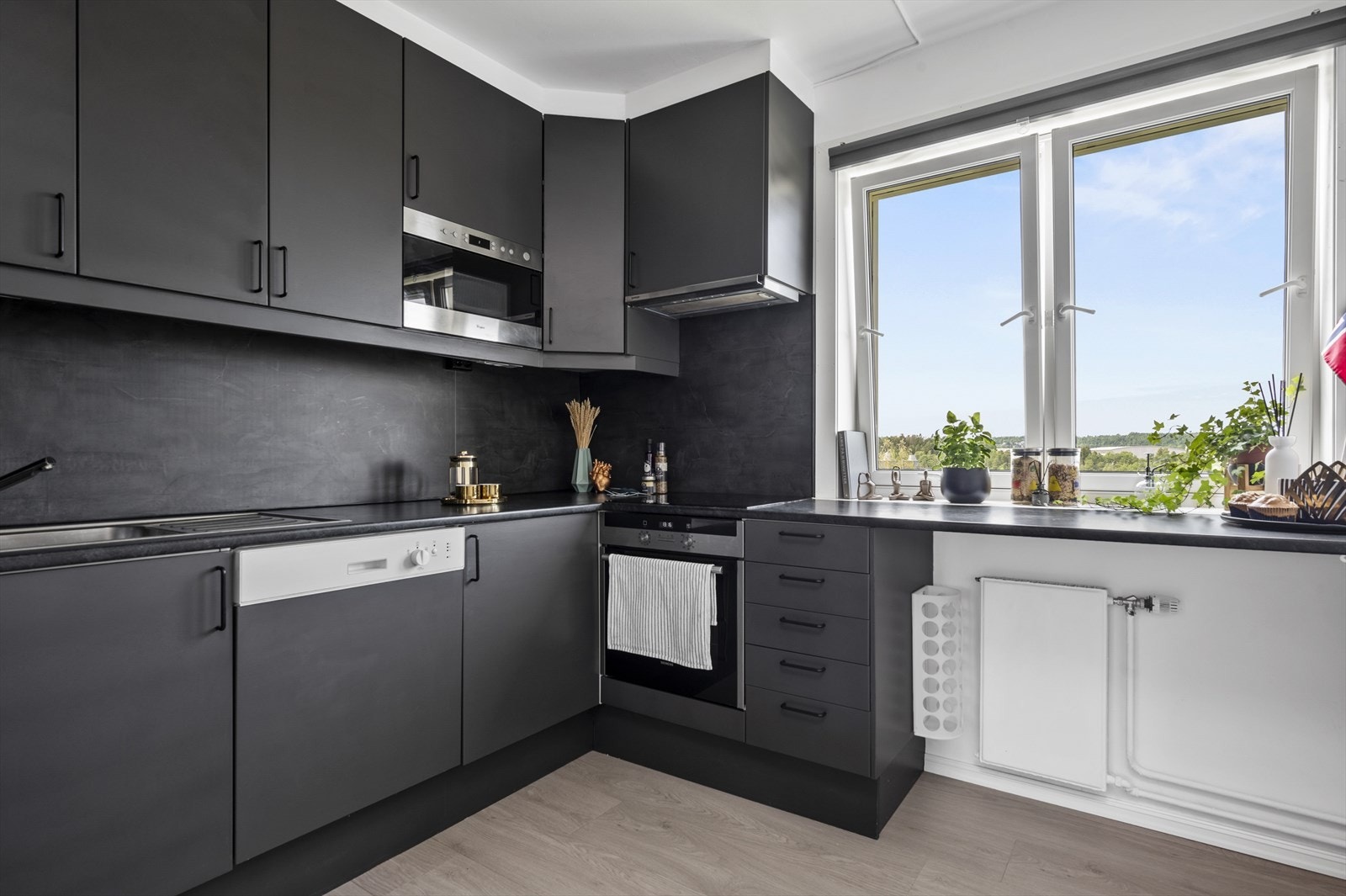 Lekkert kjøkken med integrerte hvitevarer og god benkeplass. Galleribilde