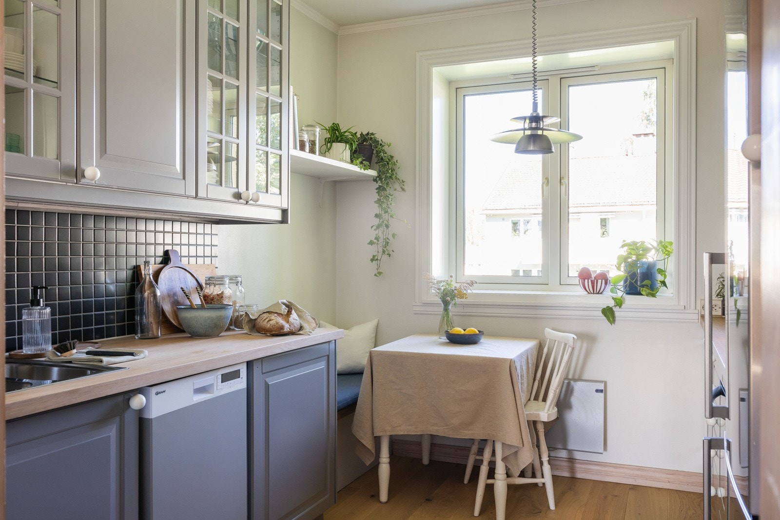 Pent kjøkken med sitteplass. Funksjonell vindusnisje dyp nok til å plassere gjenstander, planter eller andre dekorative elementer. Galleribilde