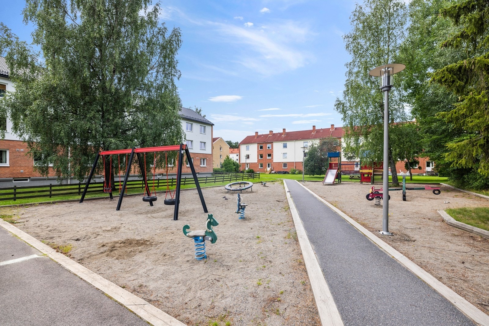Pent opparbeidet fellesarealer med sittebenker og lekeplass Galleribilde